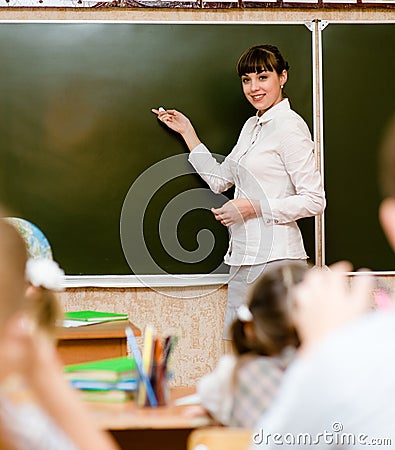 Teacher teaches students in classroom Stock Photo