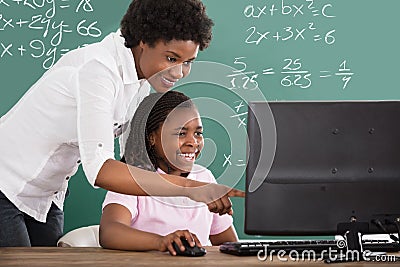 Teacher Teaching Her Student In Class Stock Photo