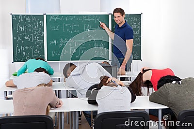 Teacher teaching mathematics to bored students Stock Photo