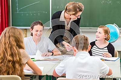 Teacher teaching students geography lessons in school Stock Photo