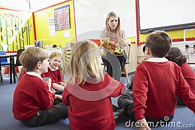 Teacher Telling Story To Elementary School Pupils Stock Photo