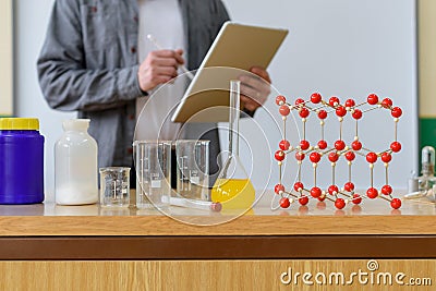 Teacher using digital tablet to teach students in chemistry class. Education, VR, Tutoring. Stock Photo