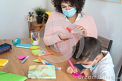 Teacher using sanitizer gel to disinfect hands with sanitizer gel - Focus on woman face Stock Photo