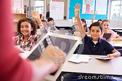Teacher using tablet computer in elementary school lesson Stock Photo