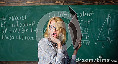 Teacher woman raising laptop above herself ready to destroy. Overstrain of the nervous system. Working conditions of Stock Photo