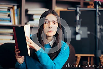 Female Educator Teaching Online Course Holding a Book Stock Photo