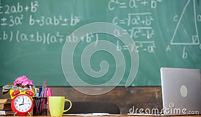 Teachers attributes. Working conditions which prospective teachers must consider. Table with school supplies alarm clock Stock Photo