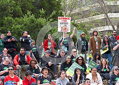 Teachers and supporters holding signs protesting at a Teacher Strike Rally in Oakland, CA Editorial Stock Photo