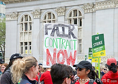 Teachers and supporters holding signs protesting at a Teacher Strike Rally in Oakland, CA Editorial Stock Photo