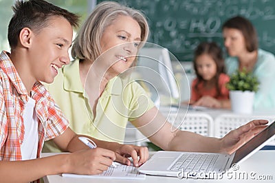 Teachers working with pupils Stock Photo