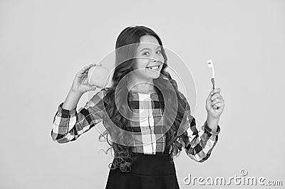 Teaching kids cleaning teeth. Oral hygiene. Girl cute hold toothbrush and apple. Child girl hold brush tooth with paste Stock Photo