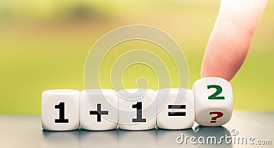 Teaching mathematics. Hand turns a dice and solves and equation Stock Photo