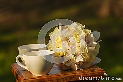 Teacups and bouquet Stock Photo