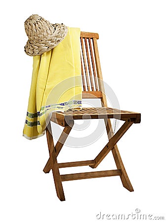 Teak deck chair with towel and hat Stock Photo