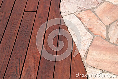 Teak wood deck and marble stone decorative tiled walkway detail, hardwood decking installed next natural marble stone slabs Stock Photo