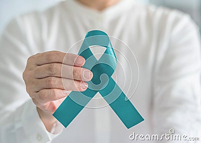 Teal awareness ribbon bow color for Ovarian Cancer, Polycystic Ovary Syndrome PCOS and Post Traumatic Stress Disorder PTSD Stock Photo