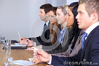 Team of 5 people sitting at conference table Stock Photo