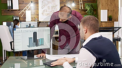 Team of architects working on the architectural structure in building models on computer Stock Photo