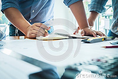 Team of architecture engineer construction with paper plan project housing. Stock Photo