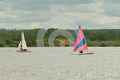 Team athletes participating in the sailing competition - yacht race, regatta. Sailboats. Recreational Water Sports, Extreme Sport Editorial Stock Photo