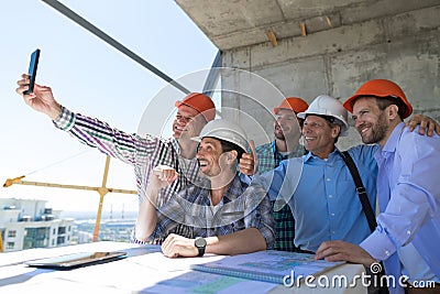 Team Of Builders Happy Smiling Take Selfie Photo During Meeting With Architect And Engineer On Construction Site Stock Photo