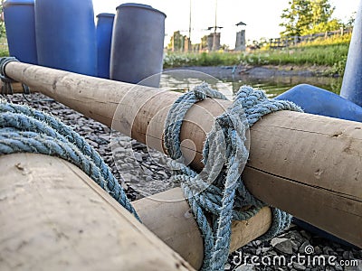 Team building raft logs tied together Stock Photo