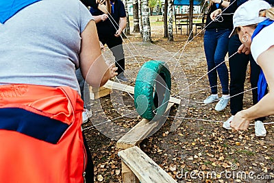 Team building team plays outdoors in summer with a wheel Editorial Stock Photo