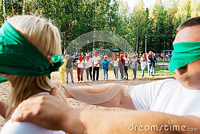Team building teams holding hands in the forest in summer Editorial Stock Photo