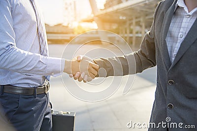 Team Business Partners shaking hands together to Greeting Start up new project. Corporate Teamwork Partnership outside office Stock Photo