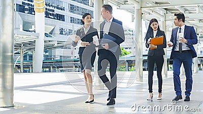 Team of business people smart man and woman walk in rush hour Stock Photo