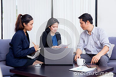 Team of business three people working together on a laptop Stock Photo