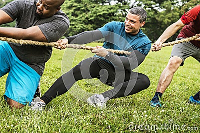 Team competing in tug of war Stock Photo