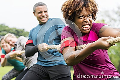 Team competing in tug of war Stock Photo
