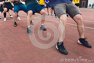 Team competing in tug of war men pull the rope. Stock Photo
