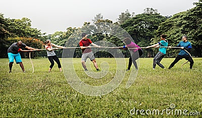 Team competing in tug of war Stock Photo