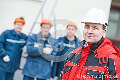 Team of construction workers technicians with foreman in front Stock Photo