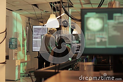 Team of diverse spies using trojan virus to access network Stock Photo