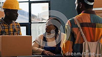 Team of employees doing quality control in storage room Stock Photo