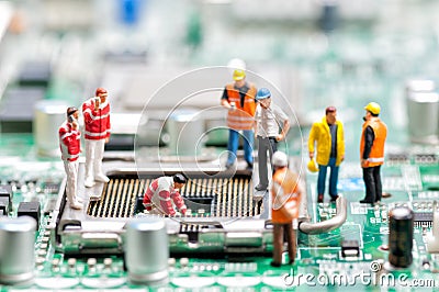 Team of engineers repairing circuit board Stock Photo