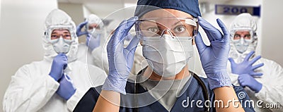 Team of Female and Male Doctors or Nurses Wearing Personal Protective Equipment In Hospital Hallway Stock Photo