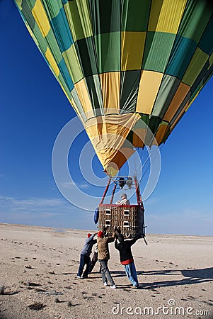 Team of helpers ensures a safe landing of a hot air balloon Editorial Stock Photo