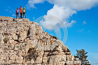 Team of hikers on the rocky summit Stock Photo