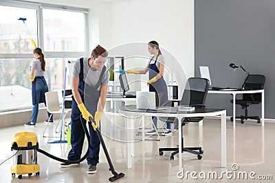 Team of janitors cleaning office Stock Photo