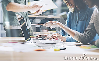 Team job. Photo young businessmans crew working with new startup project in modern loft. Generic design notebook on wood Stock Photo