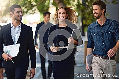 The team that keeps up with the pace of business. Shot of corporate colleagues walking down the street. Stock Photo
