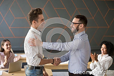 Team leader handshaking employee congratulating with professiona Stock Photo