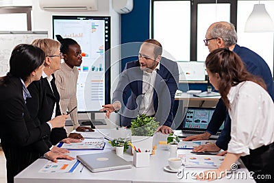 Team manager in startup business discussing with mixedrace coworkers Stock Photo