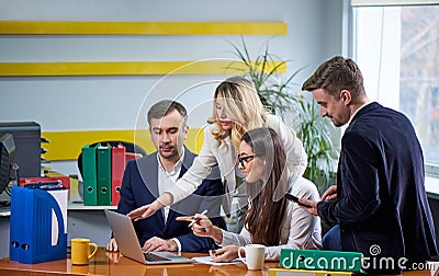 Team of mature women and men at meeting table discussing a business plan Stock Photo