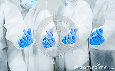 Team of medical scientific researcher standing wearing safety suit and personal protective equipment with make mini heart in lab Stock Photo