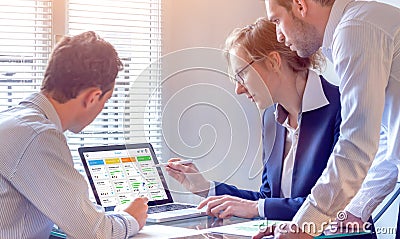 Daily team meeting around agile product development board with scrum or kanban framework, lean methodology, iterative or Stock Photo